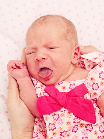 New born baby girl crying, hungry and wants to eatの写真素材