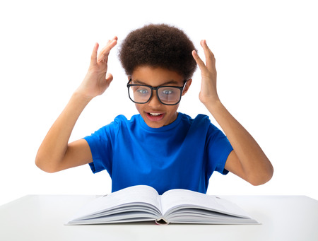 African American school boy, teenager studying hard, education and school concept - little student...