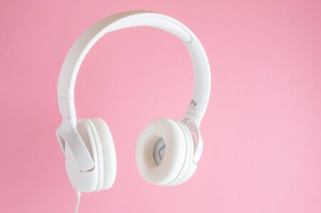 White headphones on pink background. Music concept.の写真素材