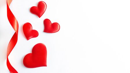 Red hearts shape and ribbon on white background. Flat lay, top view, copy spaceの写真素材