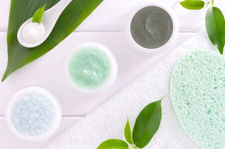 Natural organic SPA cosmetic products set: cosmetic clay, sea salt and scrub on white woodenの写真素材