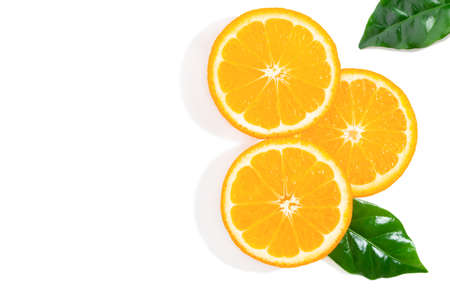 Three slices of orange fruit and green leaves isolated on white background. Creative background, top view with copy space.の写真素材