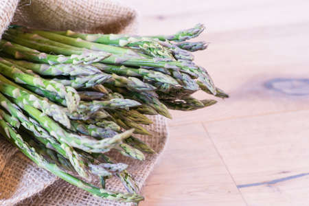 Bunch of asparagus in a jute sackの写真素材