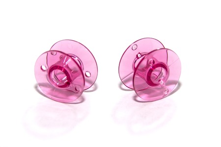 pink plastic bobbin for sewing machine on white backgroundの写真素材