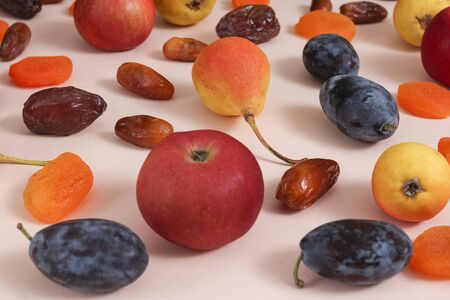 Superfoods on a pink background. Apples pears plums dates dried apricotsの写真素材