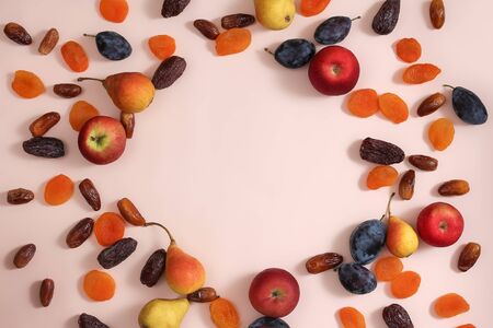 Superfoods on a pink background with a Copyspace. Apples pears plums dates dried apricotsの写真素材