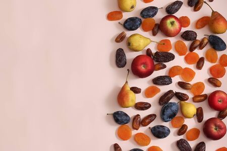 Superfoods on a pink background with a Copyspace. Apples pears plums dates dried apricotsの写真素材