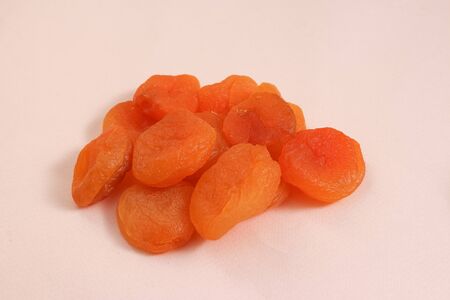 Dried apricots fruits on pink background.の写真素材