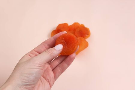 handful of dried apricots. Woman holding dried apricots.の写真素材