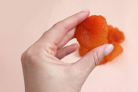 handful of dried apricots. Woman holding dried apricots.の写真素材