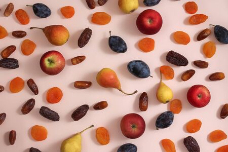Superfoods on a pink background. Apples pears plums dates dried apricotsの写真素材