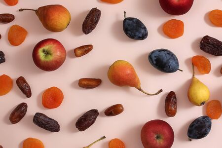 Superfoods on a pink background. Apples pears plums dates dried apricotsの写真素材