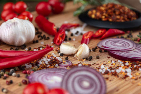 spices onion red pepper garlic on wood boardの写真素材