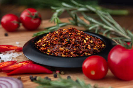 spices onion red pepper garlic on wood boardの写真素材