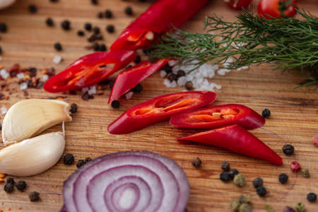 spices onion red pepper garlic on wood boardの写真素材