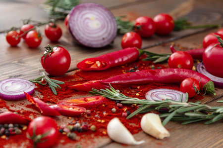 spices onion red pepper garlic on wood boardの写真素材