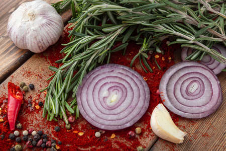 spices onion red pepper garlic on wood boardの写真素材