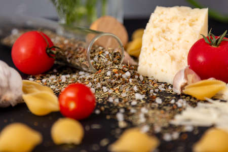 pasta shells cheese spices with red tomatoesの写真素材