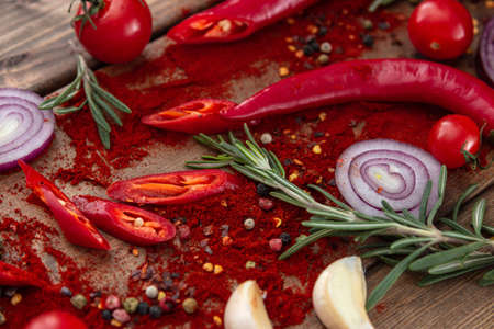 spices onion red pepper garlic on wood boardの写真素材