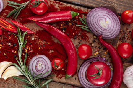 spices onion red pepper garlic on wood boardの写真素材