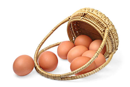 Eggs and wicker basket on a white background  の写真素材