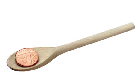 One penny on the wooden spoon isolated on whiteの写真素材