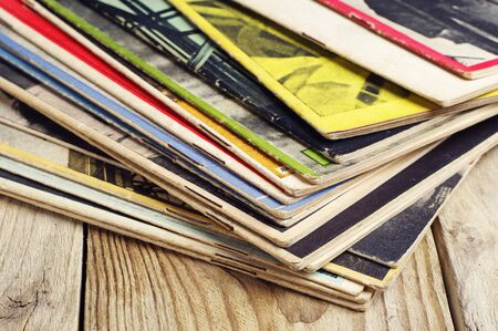 Old magazines on a wooden tableの写真素材