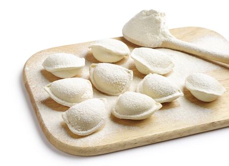 Pelmeni on a wooden background on whiteの写真素材