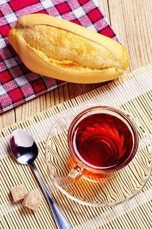 Cup of tea and white bread on table
