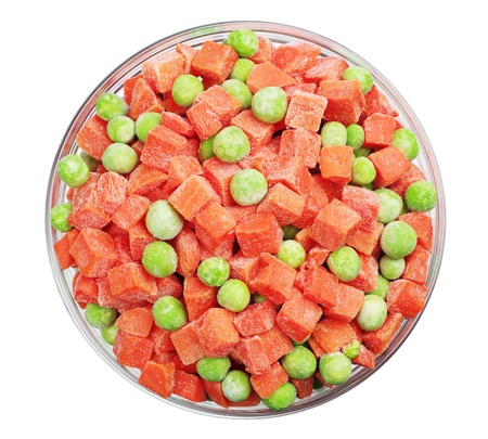 Frozen carrots and green peas in a glass bowl isolated on white. Top viewの写真素材
