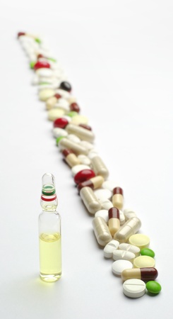 Ampule with medicine and different pills diagonallyの写真素材