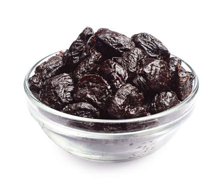 Dried plum in a glass bowl on a white backgroundの写真素材