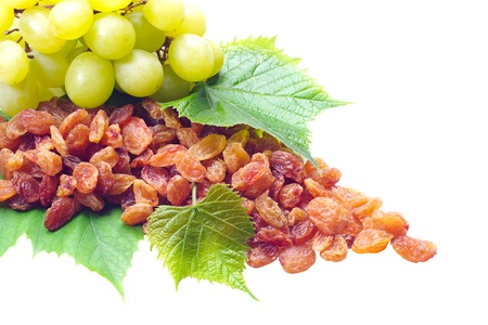 Raisins and grapes with leaves isolated on a white backgroundの写真素材