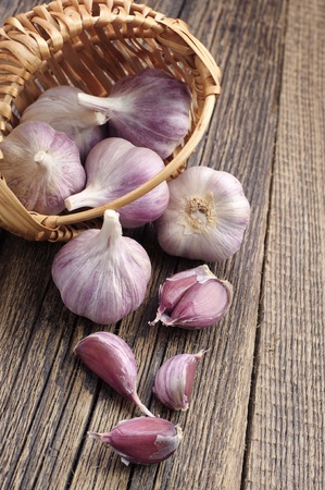 Fresh garlic and cloves on wooden tableの写真素材