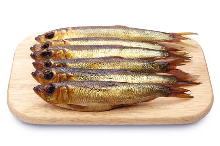 Smoked herring on a cutting board on white backgroundの写真素材