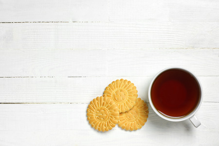 Background with cup of tea and cookies top viewの写真素材