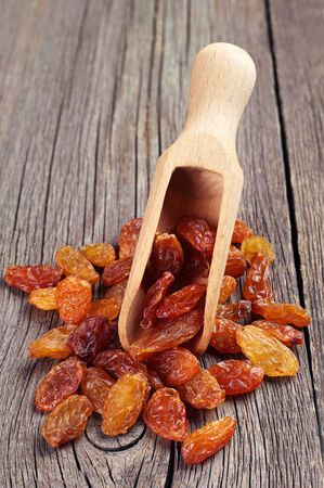 Scoop with raisins on vintage wooden backgroundの写真素材
