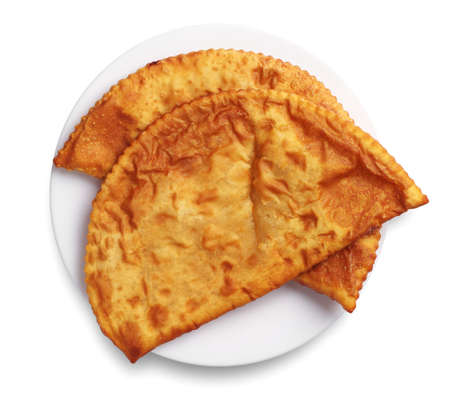 Two tasty pasties in a plate on white 