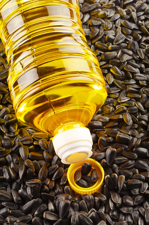 Vegetable oil in plastic bottle and sunflower seedsの写真素材