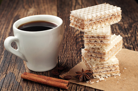 Cup of coffee and sweet waffles with condensed milkの写真素材