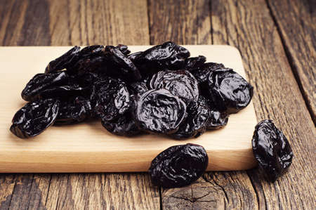 Dried plum on kitchen board closeupの写真素材