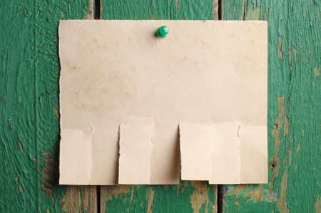 Torn paper for announcement on old wooden backgroundの写真素材