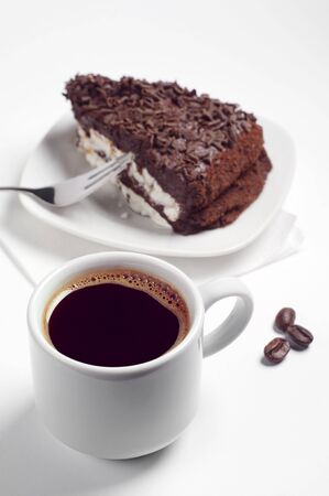 Cup of hot coffee and chocolate cake on white backgroundの写真素材