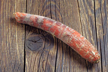 Rotten carrot on dark wooden backgroundの写真素材