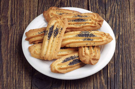 Plate with homemade cookies on dark wooden tableの写真素材