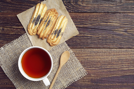 Tea cup with homemade cookies on wooden table, top viewの写真素材