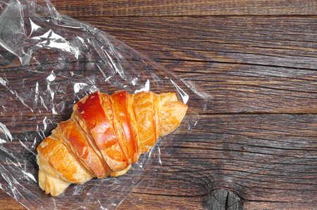 Closeup croissant on rustic table, top view