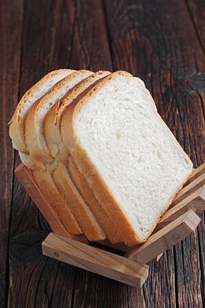 Slices of toast bread on wooden background