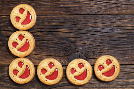 Sweet cookies with jam on wooden background, top viewの写真素材