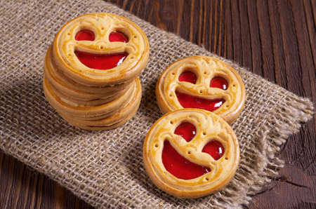 Sweet cookies with jelly on rustic wooden table close upの写真素材